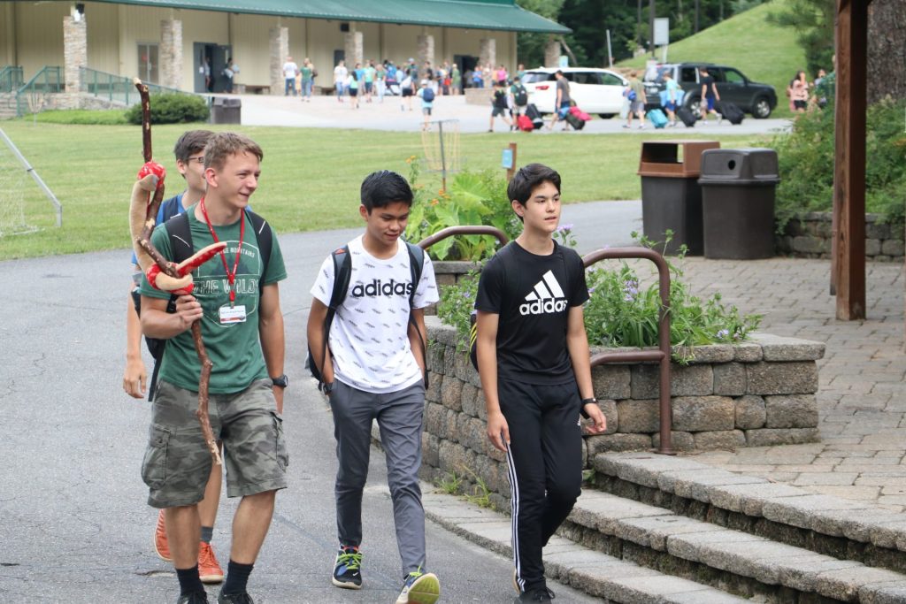 A counselor walking with a group of campers