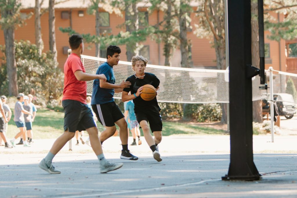 Three campers playing basketball