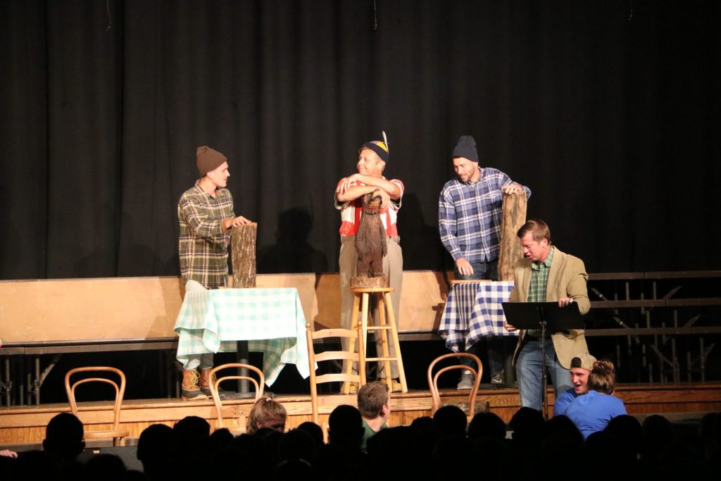Four staff on stage in costumes