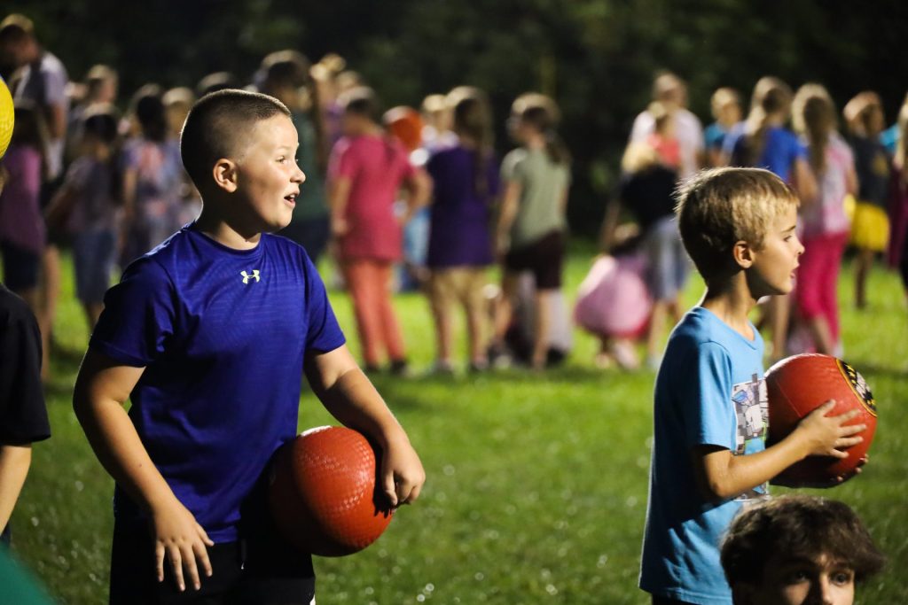 Campers holding dodgeballs at JBC ballfield
