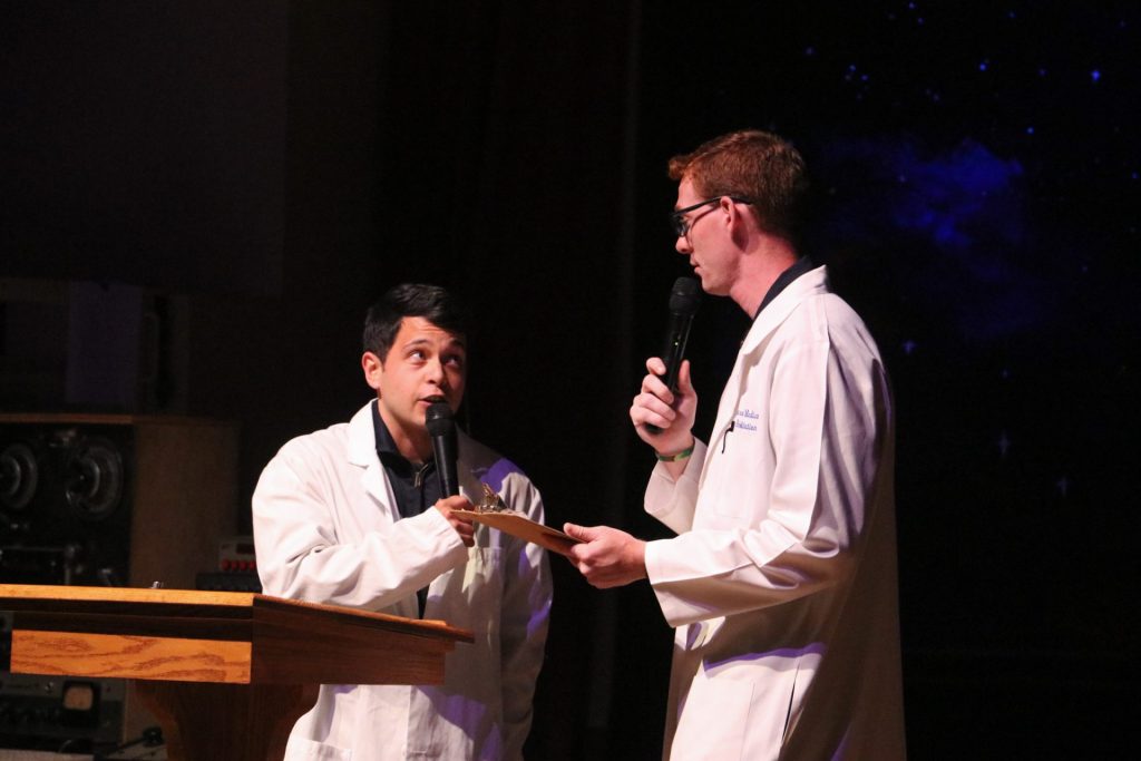 Two staff holding microphones