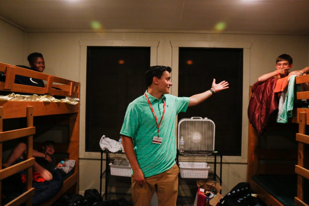 A counselor and campers in their cabin